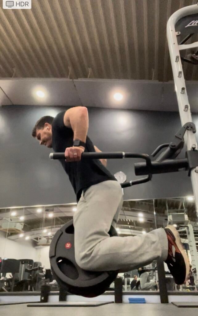 A man performing a weighted parallel bar dip. An alternative exercise to the bench press- from an article called Why you shouldn't bench press, squat and is deadlift operated.