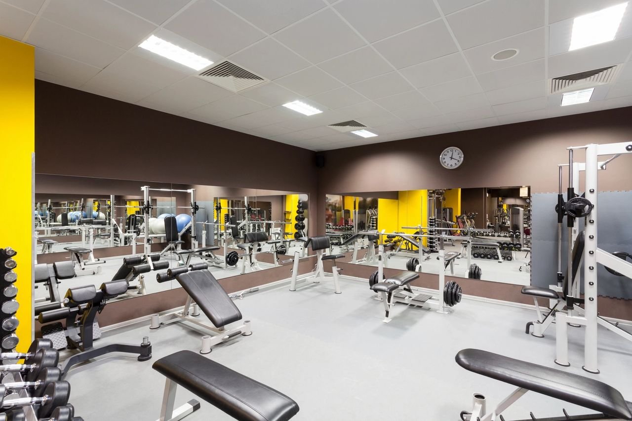 A commercial Gym showing a variety of weight training equipment. It's to show within an article the many muscle and strength building mistakes made that delay people getting ripped